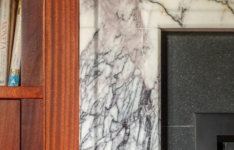 Marble-fireplace-detail-with-mahogany-panelling
